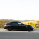 2023 mercedes-amg c 63 s e-performance in matte black photographed on the side of a mountain road in spain